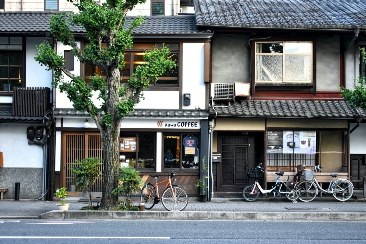 black bicycle parked beside brown and white concrete building during daytime